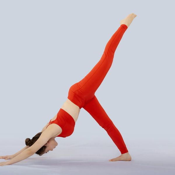 Woman performing a gentle, flowing movement in a calm, well-lit studio.